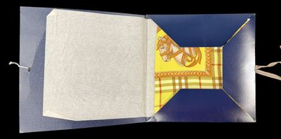an open book with a yellow and blue design on it