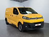 the yellow van is parked in the large room of the building