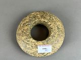 a donut with a sticker on it sitting on a table