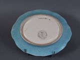 a blue and white plate with a picture of a cat on it