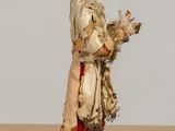 a figurine of a woman holding a cat on a table