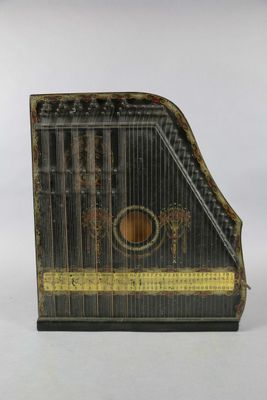 a black and gold musical instrument on a white background