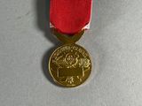 the medal has a red, white, and blue ribbon around it