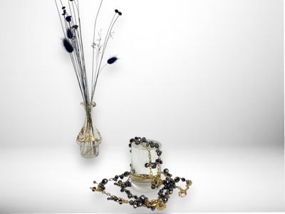 a vase with a bunch of flowers in it next to a vase with beads