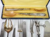 a lot of silverware in a box on a table