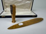 a knife and a box with a pen in it
