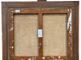 an old picture frame with a picture hanging on a wall