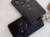 two remotes sitting next to each other on a table