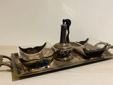 a silver tray with a tea set on it on a table