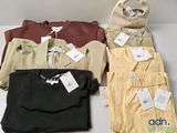 three shirts and a bag are sitting on a table