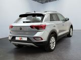 the rear end of a silver volkswagen suv parked in a showroom