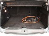 an open trunk of a car with a hose in it