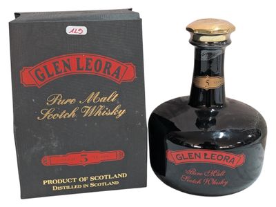 a bottle of liquor that is sitting next to a box