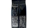 two bags of coffee sitting next to each other on a white surface