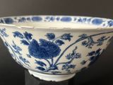 a blue and white bowl sitting on a black table