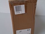 a box that is sitting on a table next to a cell phone
