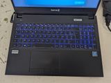 a laptop with a blue keyboard sitting on a table
