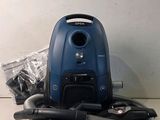 a vacuum that is sitting on the floor next to other items