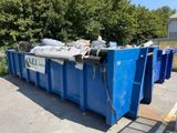 a blue dumpster sitting in the middle of a parking lot