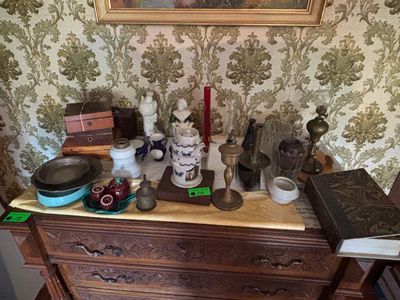 a picture of a dresser with a lot of items on top of it