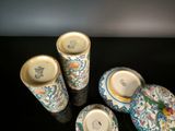 three cups and a plate sitting on a table