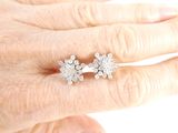 a woman ' s hand with a diamond ring on it