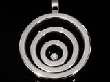 a black and white photo of a pendant with a diamond in it