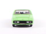 a green toy car that is sitting on a white surface