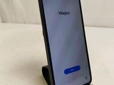 the back of a black phone with a blue button on it