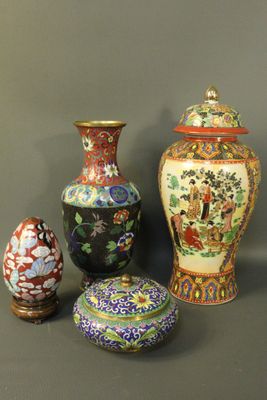 three vases and one egg sitting on a table with a gray background