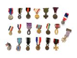 many medals and medals on display on a white surface