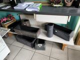several bins on a shelf in a room