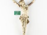 a close up of a statue of jesus on a cross with a green tag