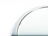 a mirror that is on the wall with a cord attached