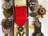 an assortment of medals and medals are displayed in a case