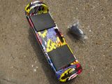 a skateboard that is laying on the ground next to a skateboard