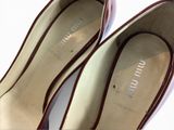 pair of women ' s shoes on a white surface with a white background