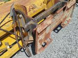a picture of a tractor with a large blade on it ' s back