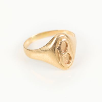 an image of a gold signet ring with a heart in the middle