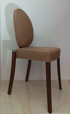 a chair that has a brown seat and a wooden frame