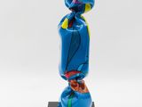 a blue sculpture of a person with a hat on it ' s head