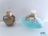 two perfume bottles that are sitting on a table
