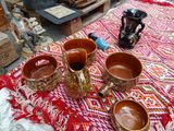 three cups on a table with a fire place in the background