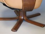 a chair that is sitting on a table with a remote control