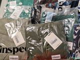 a pile of men ' s clothing on display in a store