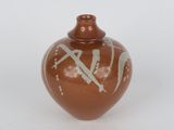 a brown vase with a design on it on a white surface
