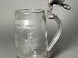 a glass mug with a handle on a table
