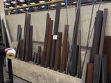 a man that is standing in front of a pile of wood