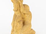 an image of a statue of a man sitting on a rock