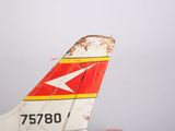 a close up view of a red, yellow and white airplane